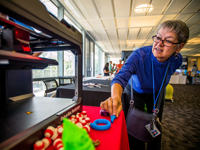 Staff member creating objects on 3d printer Staff member creating objects on 3d printer