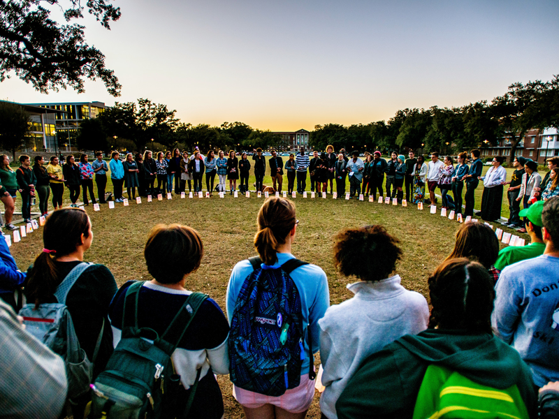 Students form a circle for a moment of silence for Transgender Day of Remembrance Students stand in circle and hold vigil on campus